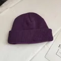 Close-up of the purple knitted beanie showing fine ribbing and cuffed detail - One Size / Dark Purple