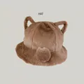 Detailed macro view of a cute brown plush bucket hat with bear ears and soft fur - Coffee