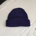 Macro view showing the texture of navy blue knitted short beanie unisex melon cap - One Size / Navy Blue
