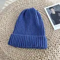 Detail view of the soft ribbed texture on a classic blue knitted winter beanie hat. - 54-58cm / Sapphire Blue