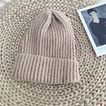 Close-up of a soft beige ribbed knit beanie hat resting on a natural woven mat background - 54-58cm / Pink