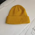 Close-up of yellow knitted short beanie with ribbed texture and a stylish folded brim - One Size / Yellow