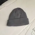 Close-up view of a classic gray knitted beanie showing detailed vertical rib-knit texture - One Size / Gray