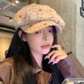 Floral patterned octagonal newsboy cap for women shown in a cozy vintage cafe setting - 56-58cm / Five-Petal Flower / Khaki
