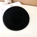 Top view detail of a classic black wool beret hat with a minimalist felt texture - 55-58cm (Stretchy) / Beret / Black