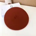 Detail view of a burnt orange wool felt beret hat with a minimalist vintage aesthetic. - 55-58cm (Stretchy) / Beret / Orange Red