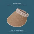 Detailed view of lavender straw sun visor hat with elegant pearl embellishment - 55-59cm / Gray