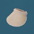 Close-up of a stylish cream straw sun visor with elegant pearl trim decoration - 55-59cm / Beige