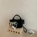 Chic black vintage bucket handbag featuring pearl bow charm and white tulip pendants - With Pendant / Black With Pendant