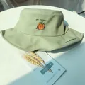 Close-up detail of a light green cotton bucket hat featuring cute pumpkin embroidery - 56-58cm / Fruit Green (Pumpkin Embroidery)