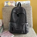 Detailed view of black backpack with white star patterns and striped side pockets. - No Pendant / Black
