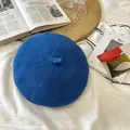 Top-down view of a blue knitted octagonal beret on a white minimalist background - 55-59cm / Blue