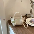 Retro off-white bucket bag with unique knot handles and elegant pearl tulip charm - With Pendant / White with Pendant