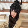 Cozy black knitted pom-pom beanie featuring colorful speckles and protective warm earflaps - 56-59cm (Elastic) / Black