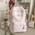 Detailed close-up of pink star pattern school backpack in a cozy lifestyle desk setting - With Pendant / Pink