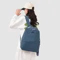 Rear view of a model wearing a blue Japanese style casual sports backpack for students - Haze Blue