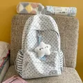 Detailed view of a grey star-patterned school backpack with a plush star pendant - With Pendant / Light Gray