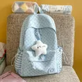 Close-up of light blue star pattern backpack with plush star charm and striped side pockets - With Pendant / Blue