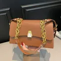 Detailed view of brown leather square crossbody bag with stylish gold chain strap - Brown