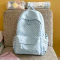 Close-up of light blue star pattern backpack with front zipper pocket and side drawstring bags - No Pendant / Blue