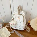Detailed close-up of a white Korean style school backpack with cute bear and star patterns - Cream Coffee Bear (With Pendant)