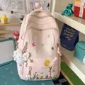 Pink student backpack with floral embroidery and cute plush doll keychain detail - With Charm / Pink