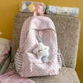 Close-up of a pink star pattern school backpack with plush star charm on a chair - With Pendant / Pink
