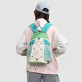 Back view of a woman wearing a stylish small green and beige outdoor hiking backpack - Mint Green