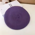 Flat lay detail view of a classic deep purple wool beret hat with a felt texture. - 55-58cm (Stretchy) / Beret / Taro Purple