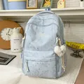 Detail view of a light blue patterned backpack in a cozy home setting - Blue