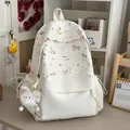 Detailed shot of a cute white cartoon pony backpack in a cozy desk setting - White with Pendant