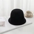 Detailed macro view of black lamb wool bucket hat with soft texture on a minimalist setup - 55-58cm / Black
