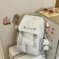 Close-up of star pattern backpack with plush bear charm sitting on a silver suitcase - With Pendant / Light Gray