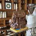 Stylish vintage brown faux leather backpack with dachshund charm in a cozy cafe setting - With Pendant / Brown