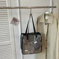 Close-up detail of a large capacity grid pattern tote bag with a matching pouch. - Large Capacity Grid Tote Bag Set / Black