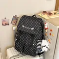 Detailed view of black backpack with white star print and striped side pocket - With Pendant / Black