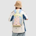 Back view of a stylish pastel multi-color backpack worn by a person on gray background - Milk Yellow Blue