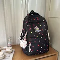 Detailed view of black polka dot backpack with cute cat embroidery and bear plush keychain - Black