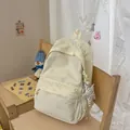 Detail view of a stylish cream backpack with silver star patterns and a star charm - With Charm / White