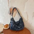 Vintage style denim crossbody bag featuring metal zipper accents and adjustable buckle straps - Dark Blue