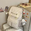Stylish 2026 women's star pattern backpack shown in a cozy lifestyle indoor setting. - With Pendant / Beige