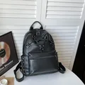 Stylish black leather women's backpack featuring unique pentagram straps and silver studs - Black