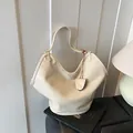 Elegant large cream-colored textured faux leather hobo bag with slouchy designer look - White