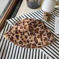 Macro detail view of a trendy leopard print faux fur bucket hat with soft plush texture - Leopard Print