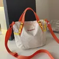 Stylish white checkered crossbody bag with vibrant orange straps and yellow details - White