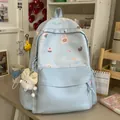 Close-up of a cute light blue student backpack with cartoon animal patterns and bow charm - With Charm Style / Blue