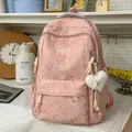 Large pink school backpack with cute heart bow patterns and a heart-shaped plush keychain - Pink