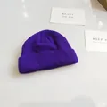 Detailed view of a stylish purple ribbed knit beanie showing soft texture and folded brim - 54-58cm / Purple