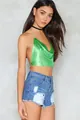 Detail view of a vibrant green metallic mesh backless halter top styled with denim shorts - One Size / Tops / Green