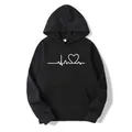Detail of white ECG heartbeat and heart print on a premium black fleece hoodie - S / Tops / Black